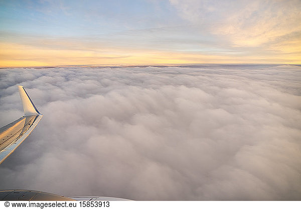 View from airplane by sunrise over the clouds in Valencia