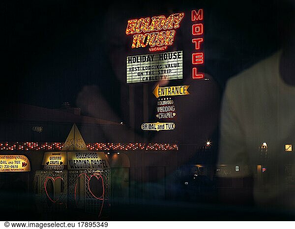 View from bus of neon lights and two hearts  neon sign for hotel and wedding chapel  Wedding Chapel at night  passengers reflected in window pane  Las Vegas Strip  Las Vegas  Nevada  USA  North America