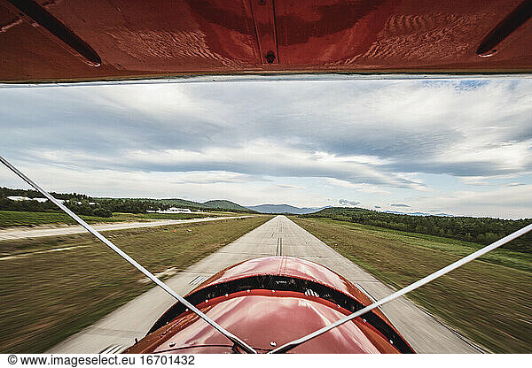 view from cockpit of vintage plane as it lands on runway in Maine