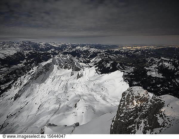View from Säntis to snow-covered mountain landscape at full moon  Säntis  Alpstein massif  Appenzell  Switzerland  Europe