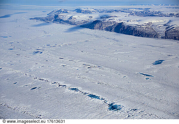 View from the Twin Otter aeroplane window looking out of miles and miles of ice.; Northeast Greenland   Greenland