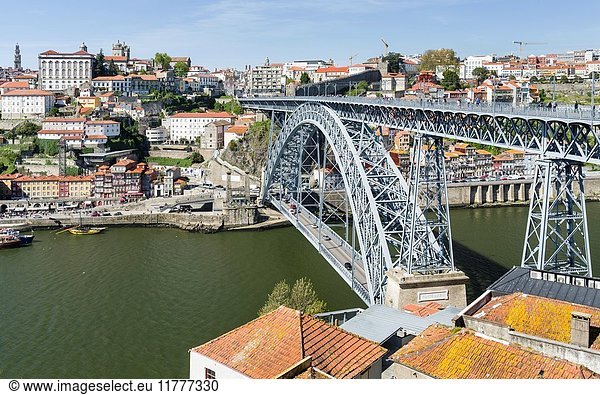 View from Vila Nova de Gaia towards Porto with the old town and the bridge Ponte Dom Luis I. City Porto (Oporto) at Rio Douro in the north of Portugal. The old town is listed as UNESCO world heritage. Europe  southern Europe  Portugal  April.