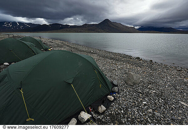 View looking over the three green tents at base camp on the shore of lake Centrum S??.; Northeast Greenland   Greenland