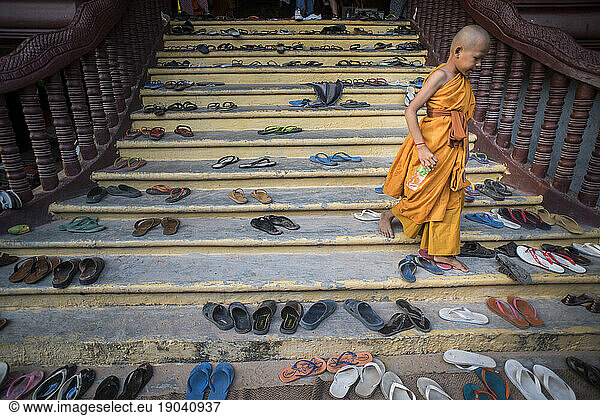 View of a buddhist monk using stairs full of platic sandals  Angkor Wat  Siem Reap  Cambodia.
