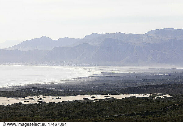 View of a mountain range and river estuary  mist and sea fret  coastline.