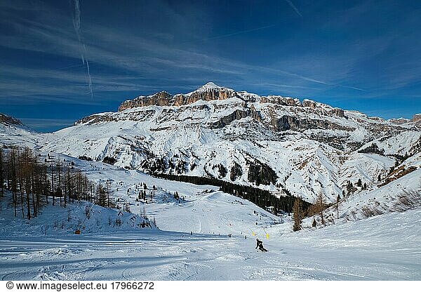 View of a ski resort piste with people skiing in Dolomites in Italy  Ski area Arabba  Arabba  Italy  Europe