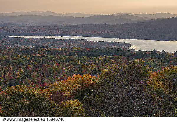 View of autumn colors and a lake with mountains in the distance