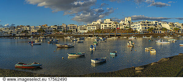 View of boats in Baha de Arrecife Marina surrounded by shops  bars and restaurants at sunset  Arrecife  Lanzarote  Canary Islands  Spain  Atlantic  Europe