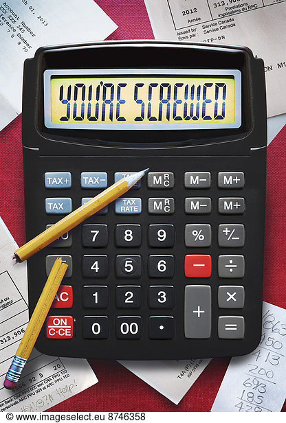 view of calculator with broken pencil and tax forms