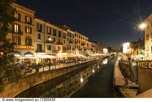 View of canal waterfront in Navigli district at night  Milan  Italy