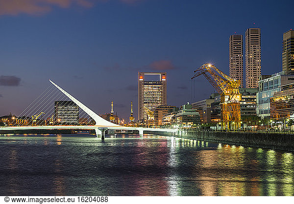 View of docks and Puente de la Mujer footbridge at night  Puerto Madero  Buenos Aires  Argentina