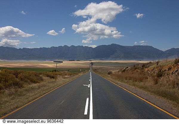 View of empty road passing through a landscape