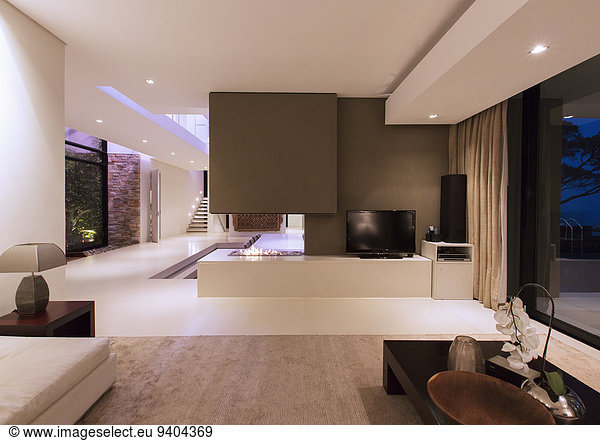 View of fireplace in luxurious living room during night