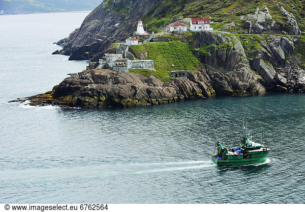 View of Fishing Boat and Fort Amherst Lighthouse  at the Entrance to St. John's Harbour  Avalon Peninsula  St. John's  Newfoundland