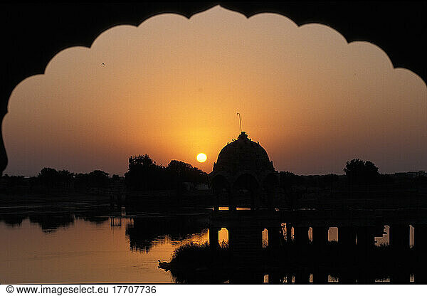 View of Gadi Sagar Tank through archway at sunrise; Jaisalmer  Rajasthan  India