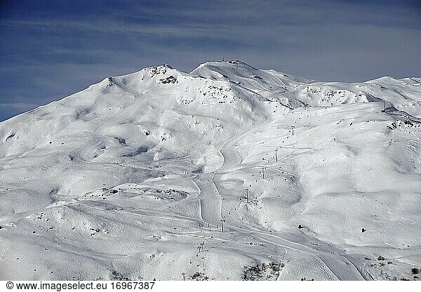 View of La Masse peak with ski slopes Les Menuires Trois Vallees ski area Haute Savoie France Europe