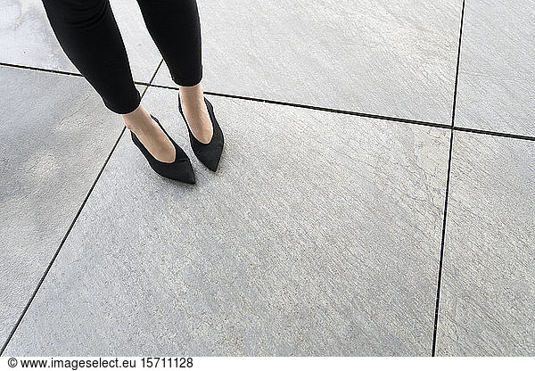 View of legs of the woman with shoes on floor
