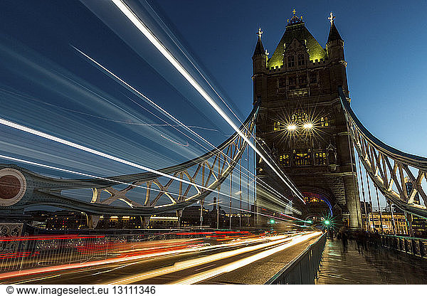 View of light trails at Tower Bridge against clear sky at night