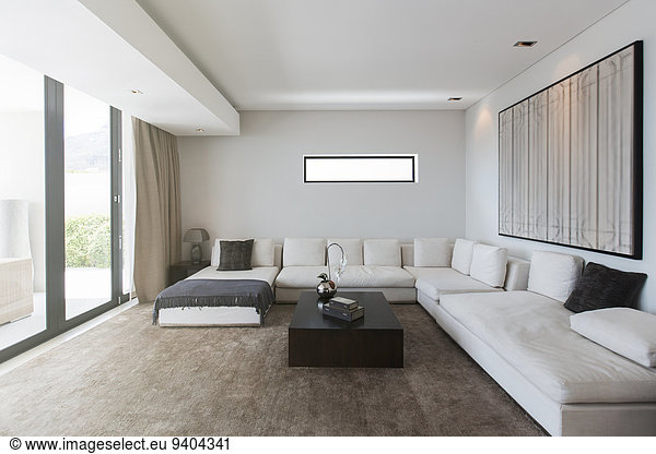 View of modern living room with sofas  coffee table and abstract painting