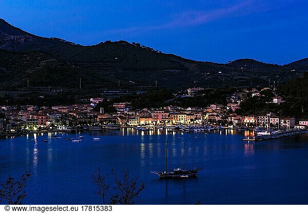 View of Porto Azzurro with illuminated harbour promenade in evening mood during blue hour  Porto Azzurro  Elba  Tuscany  Italy  Europe