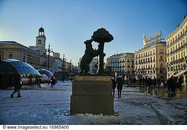 View of Puerta del Sol Square and Oso and Madrono Statue with people taking pictures and enjoying the snowy landscape on January 11  2021 in Madrid  Spain. Storm Filomena brought more than 50cm of snow to the Spanish capital  the most in decades.