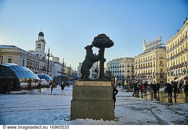 View of Puerta del Sol Square and Oso and Madrono Statue with people taking pictures and enjoying the snowy landscape on January 11  2021 in Madrid  Spain. Storm Filomena brought more than 50cm of snow to the Spanish capital  the most in decades.