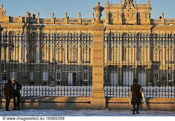 View of Royal Palace with a big withe snow square at sunset with people taking pictures and enjoy with snow landscape on January 11  2021 in Madrid  Spain. Storm Filomena brought more than 50cm of snow to the Spanish capital  the most in decades.