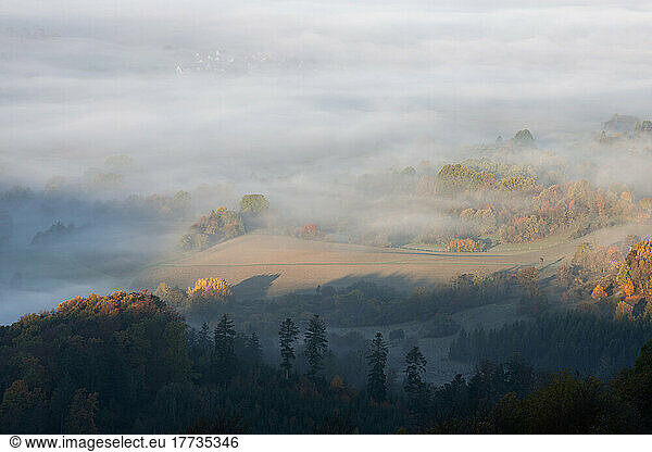 View of Swabian Alps shrouded in thick morning fog
