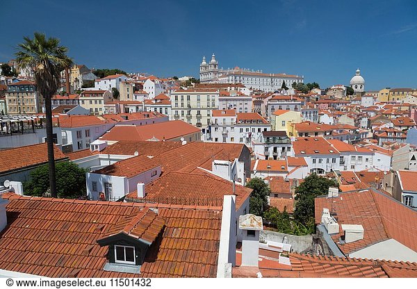 View of terracotta roofs and the ancient castle and dome from Miradouro Alfama viewpoint of Lisbon Portugal Europe.