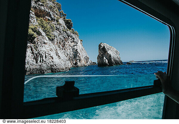 View of the Rocky Sea Coast trough the Ship Window