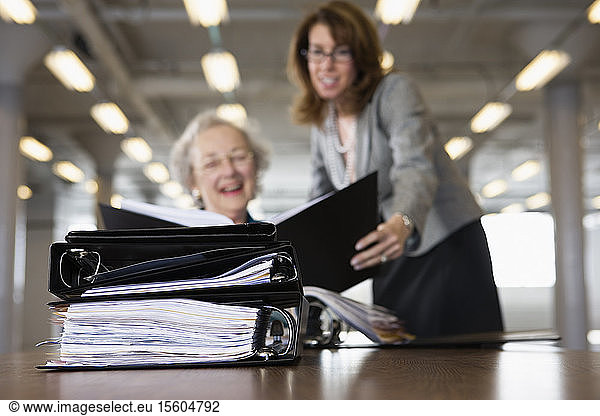 View of two business women looking at a file.