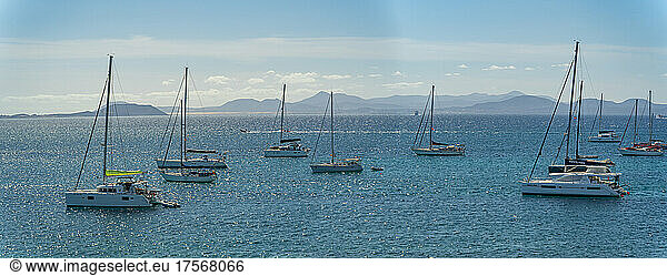 View of watersport  sailboats and Fuerteventura in background  Playa Blanca  Lanzarote  Canary Islands  Spain  Atlantic  Europe