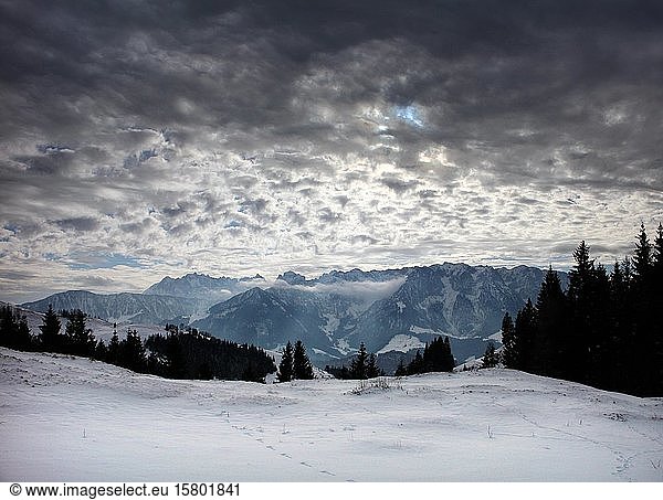 View of Zahmer and Wilder Kaiser in winter  Dramatic lighting mood  Wandberg  Chiemgau Alps  Upper Bavaria  Bavaria  Germany  Europe