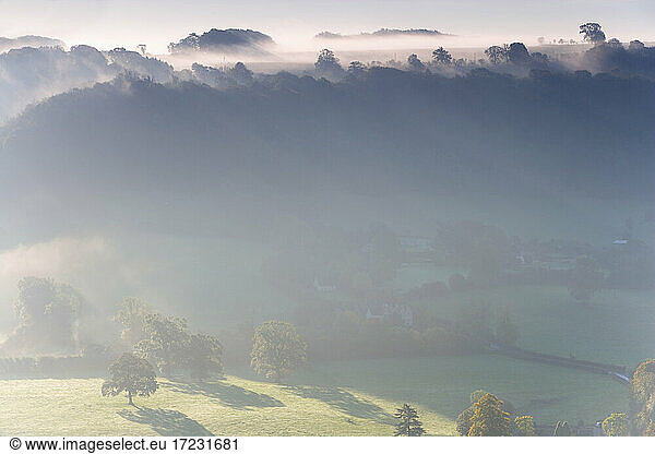 View over Uley village in the Cotswolds  mist and cloud.