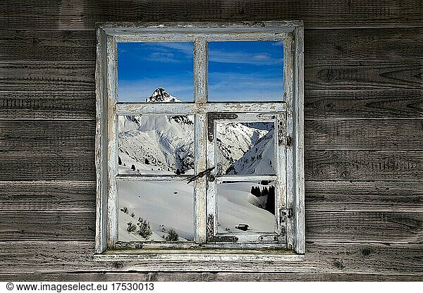 View through a rustic wooden window of the Lechtal Alps  winter  Lech  Vorarlberg  composing  Austria  Europe