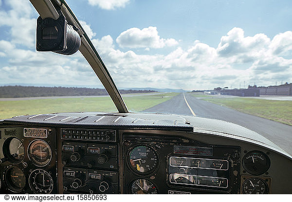 View through front windshield of a small airplane going down runway