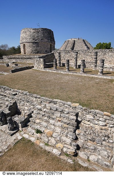 View to the Templo Redondo-Round Temple and visitors standing at the top of the Castle of Kukulcan-Castillo de Kukulcan in Mayapan Archaeological site  Merida   Yucatan State  Mexico  Central America.