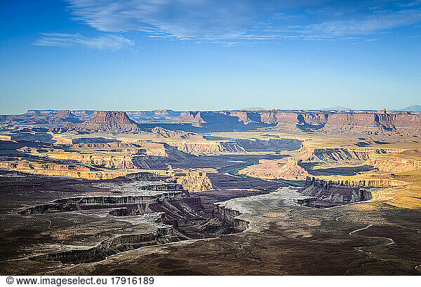Views across the canyons of the Canyonland National Park at sunset  sandstone ridges and cliffs and the Colorado River.