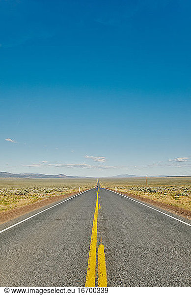 Views of an empty open road in Oregon during a summer road trip.