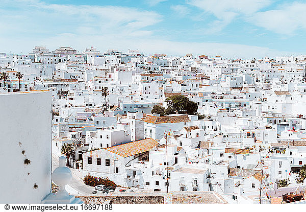 Village of white houses against blue sky in Southern Spain