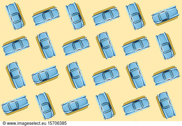 Vintage blue cars pattern on pastel yellow background