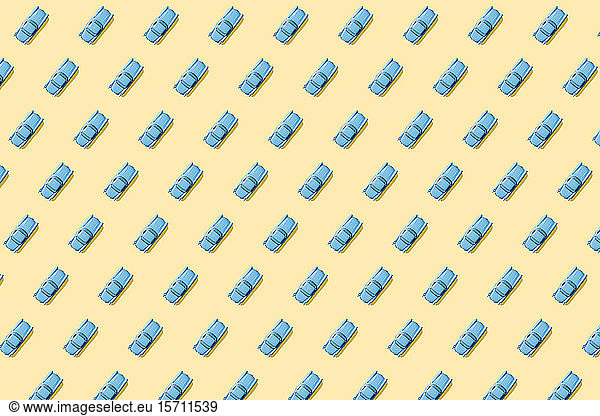 Vintage blue cars pattern on pastel yellow background
