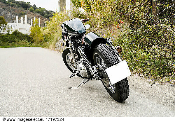 Vintage caferacer motorbike parked alone in a country road