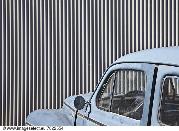 Vintage Car in Front of a Metal Wall