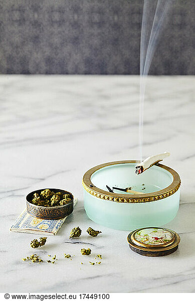 vintage looking cannabis still life with joint burning