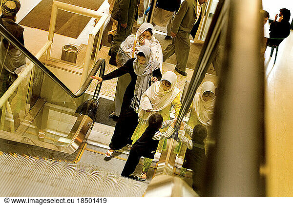 Visitors to a new mall in Kabul try out Afghanistan's only escalator for the first time.