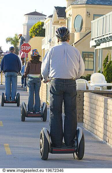 Visitors to the boardwalk at Newport Beach  California ride the segway people mover as their mode of transport.