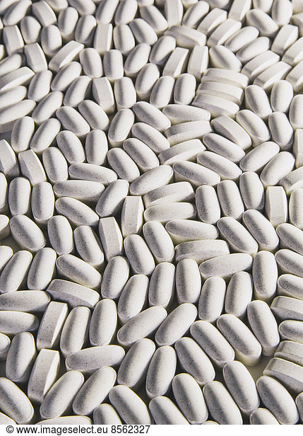 Vitamin C supplements  white oval tablets for consumption.