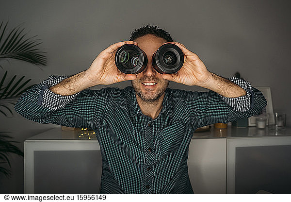Vlogger looking through lenses