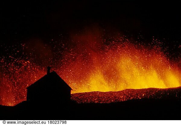 Volcanic eruption  erupting lava with townhouse silhouette  Eldfell volcano  Heimaey  Westman Islands  Iceland  1973  Europe